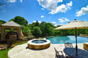 Flower Mound Infinity Pool with Water Wheel Claffey Pools