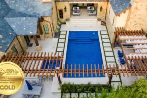 bird's eye-view of geometric pool with wooden arbor