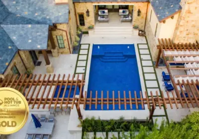 bird's eye-view of geometric pool with wooden arbor