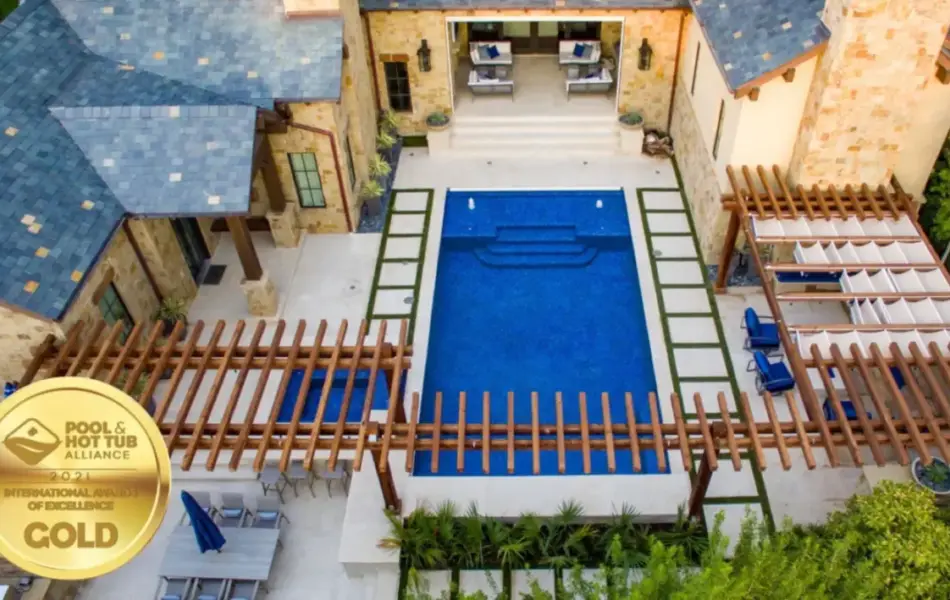 bird's eye-view of geometric pool with wooden arbor