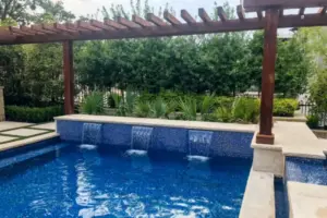wooden arbor alongside geometric pool with water features