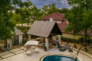 bird's eye-view of freeform pool with integrated spa and cabana for outdoor living area
