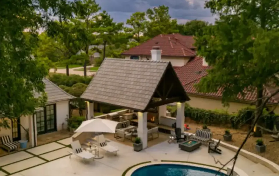 bird's eye-view of freeform pool with integrated spa and cabana for outdoor living area