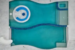 bird's eye-view of freeform pool with integrated sunken firepit