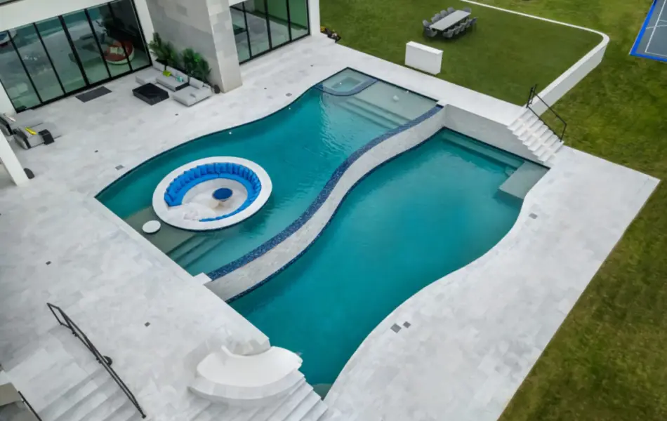bird's eye-view of freeform pool with integrated sunken firepit and slide