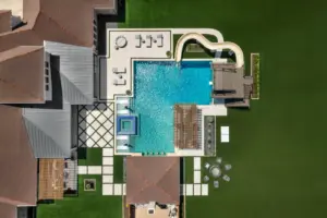 bird's eye-view of luxury pool with pool slide, integrated spa and tanning ledges