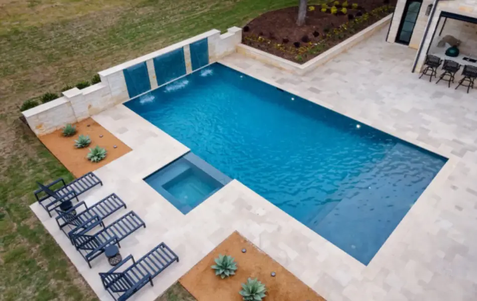 bird's eye-view of geometric pool with integrated spa and tanning ledges