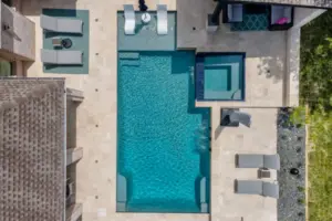 Bird's-eye view of geometric pool with adjoining spa