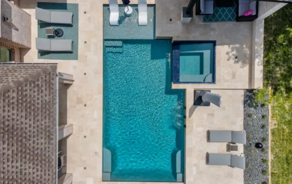 Bird's-eye view of geometric pool with adjoining spa