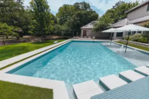 pool side view of pool with tanning ledges