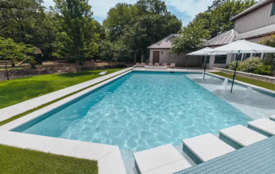 pool side view of pool with tanning ledges