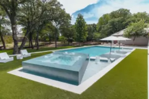 pool side view of integrated spa with water features